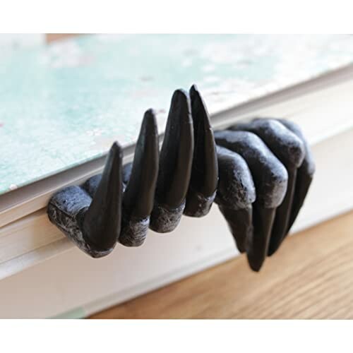 Dinosaur claw bookmark on a book