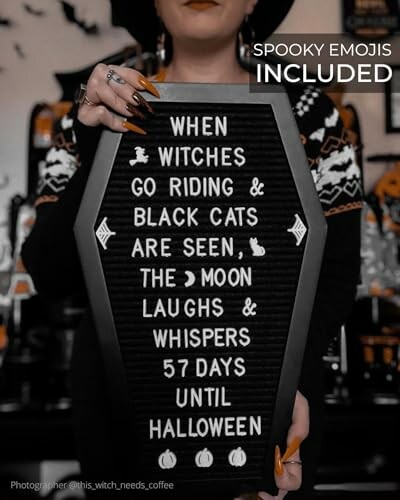 Person holding a coffin-shaped sign with Halloween countdown and message.
